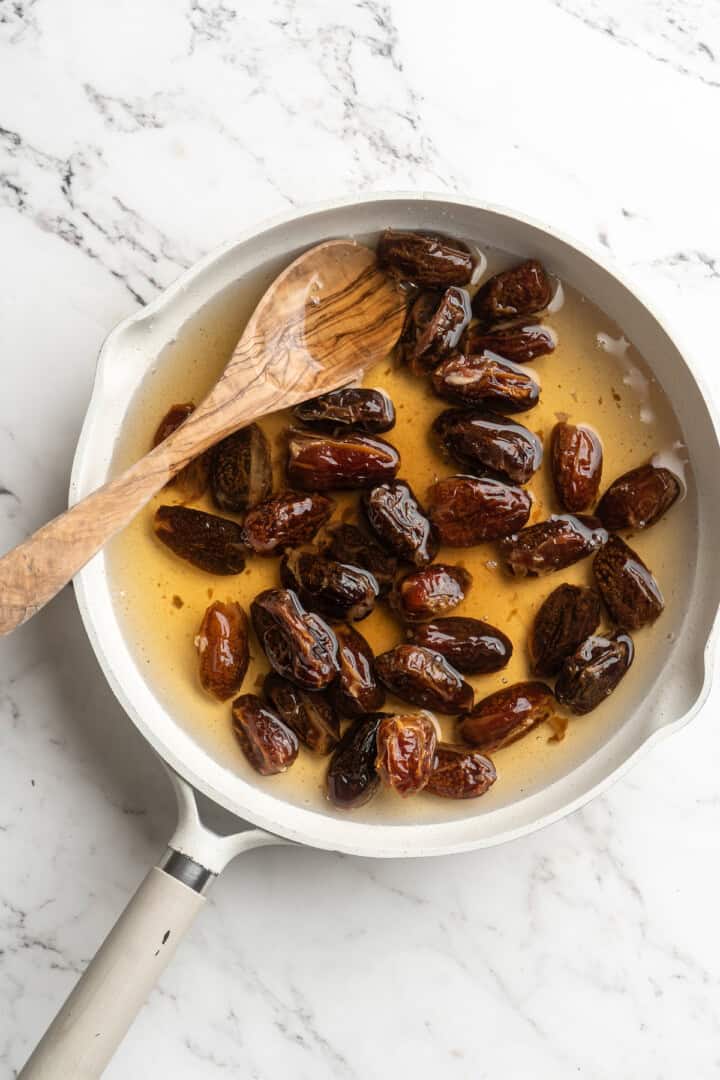 Overhead view of dates and water in saucepan