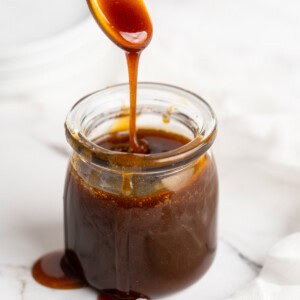 Spoon drizzling date syrup into jar