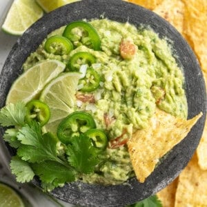 Overhead view of guacamole in bowl surrounded by tortilla chips