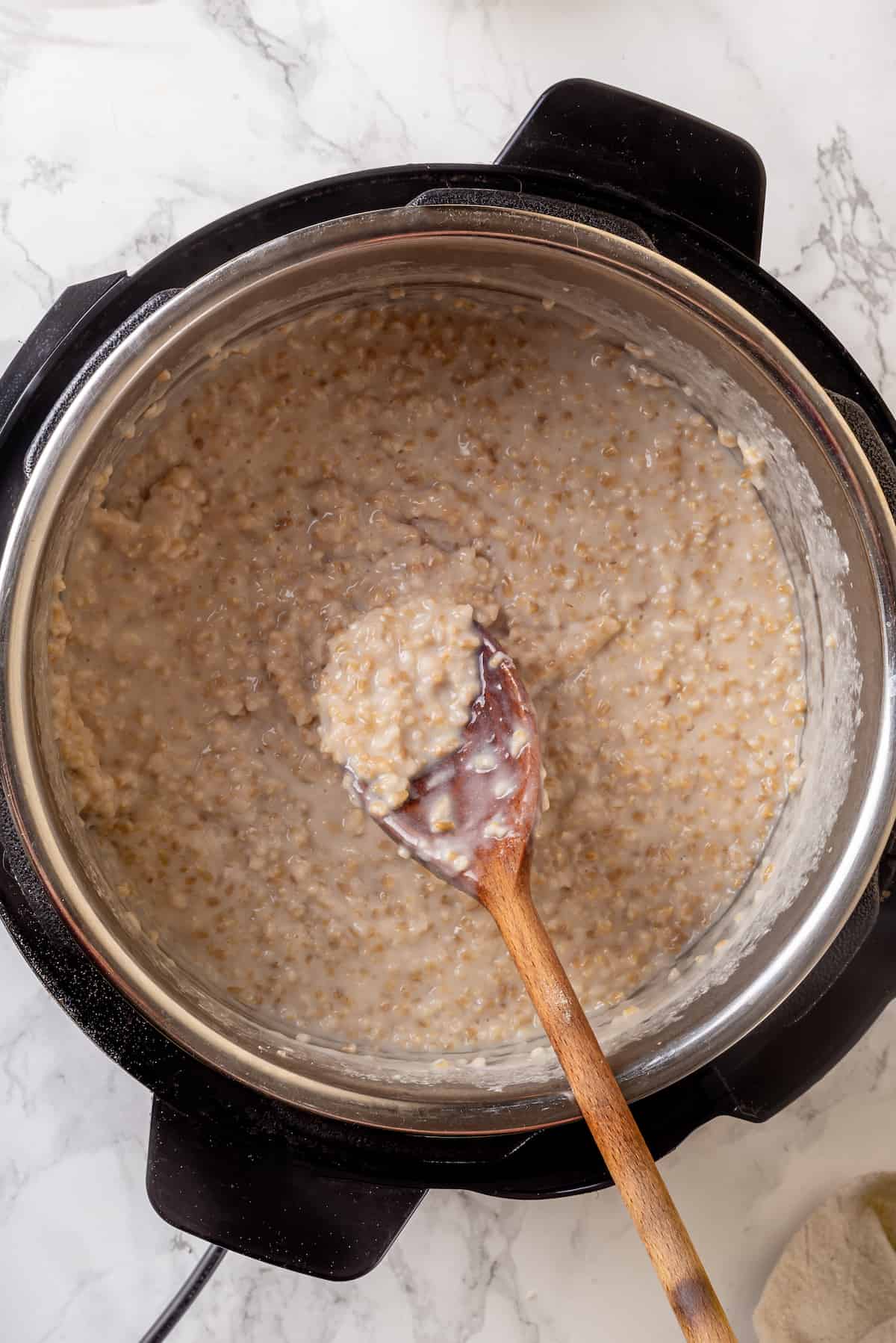 Overhead view of Instant Pot steel-cut oats with wooden spoon