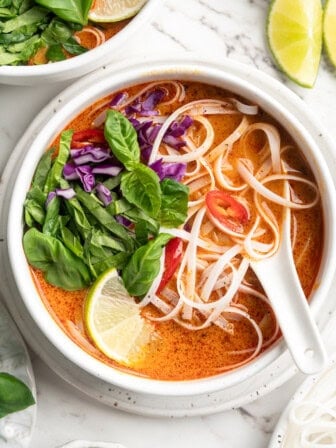 Overhead view of Thai coconut curry soup with noodles