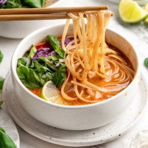 Thai coconut curry soup with noodles in bowl