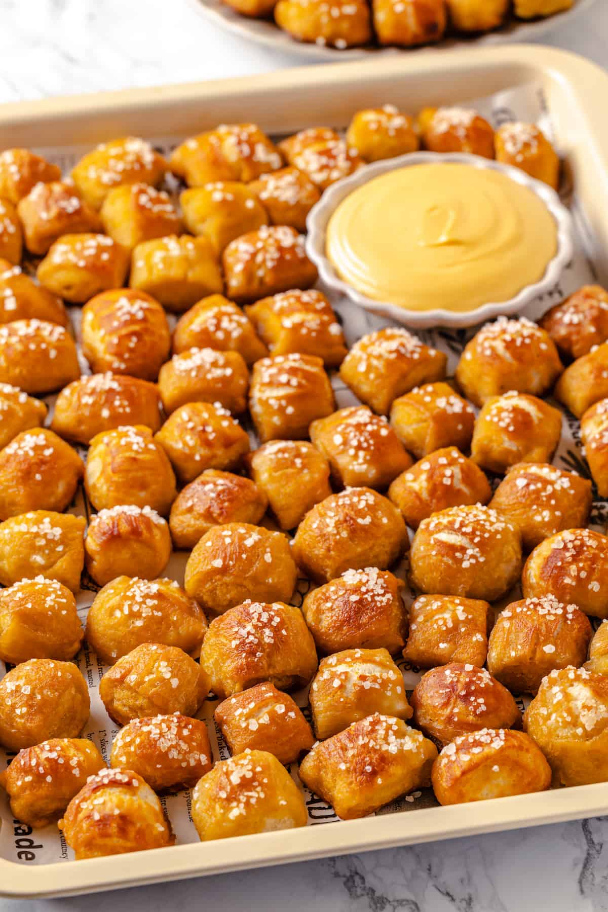 Tray of pretzel bites with bowl of cheese dip