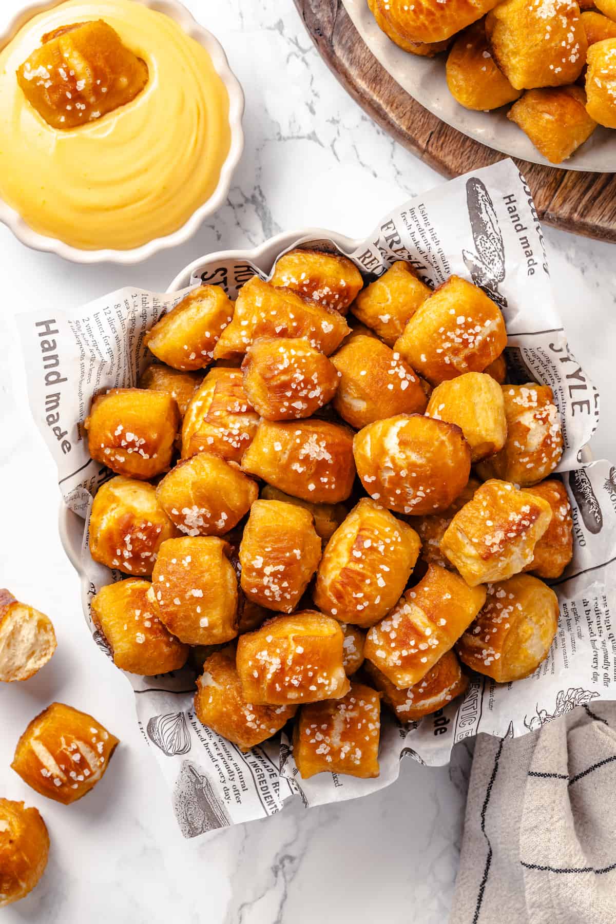 Basket of pretzel bites with bowl of cheese dip