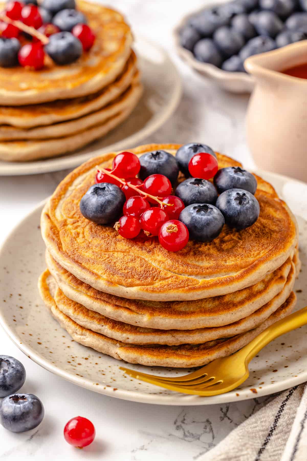 Stack of 4 protein pancakes topped with berries