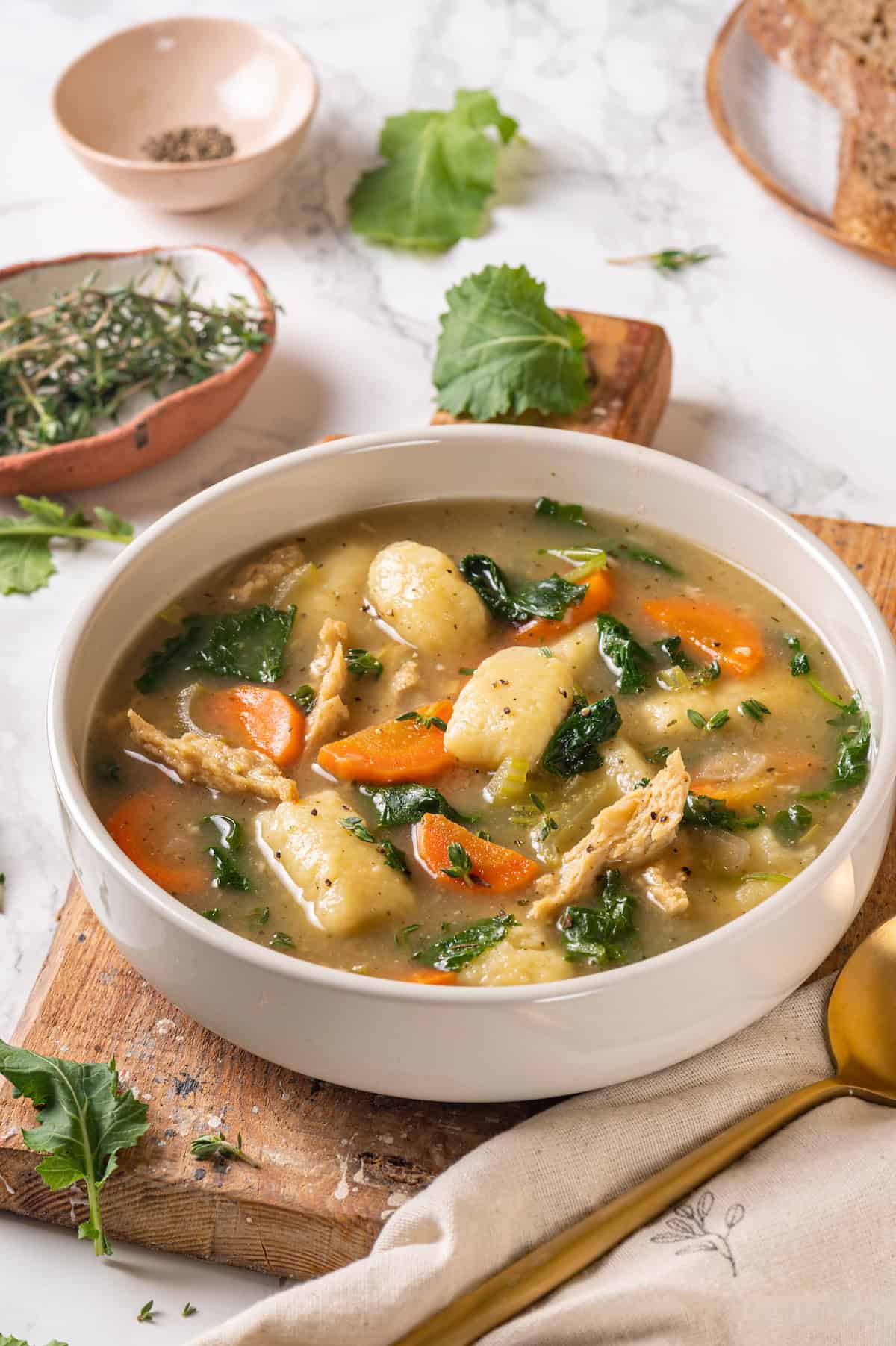 Bowl of gnocchi soup with kale and vegan chicken