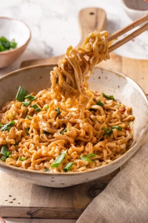 Picking up peanut butter ramen with chopsticks