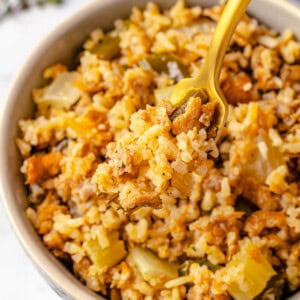 Vegan dirty rice on fork over bowl