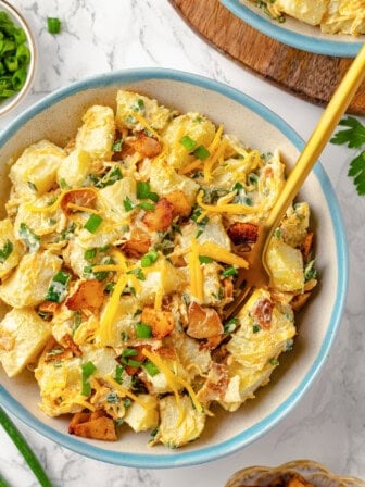 Overhead view of loaded potato salad with fork