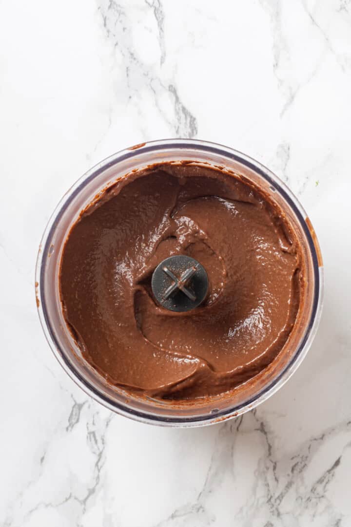 Overhead view of avocado chocolate mousse in food processor bowl