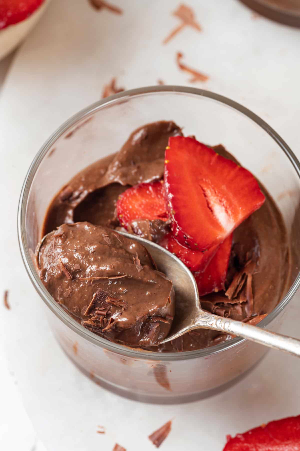 Ramekin of chocolate avocado mousse with spoon