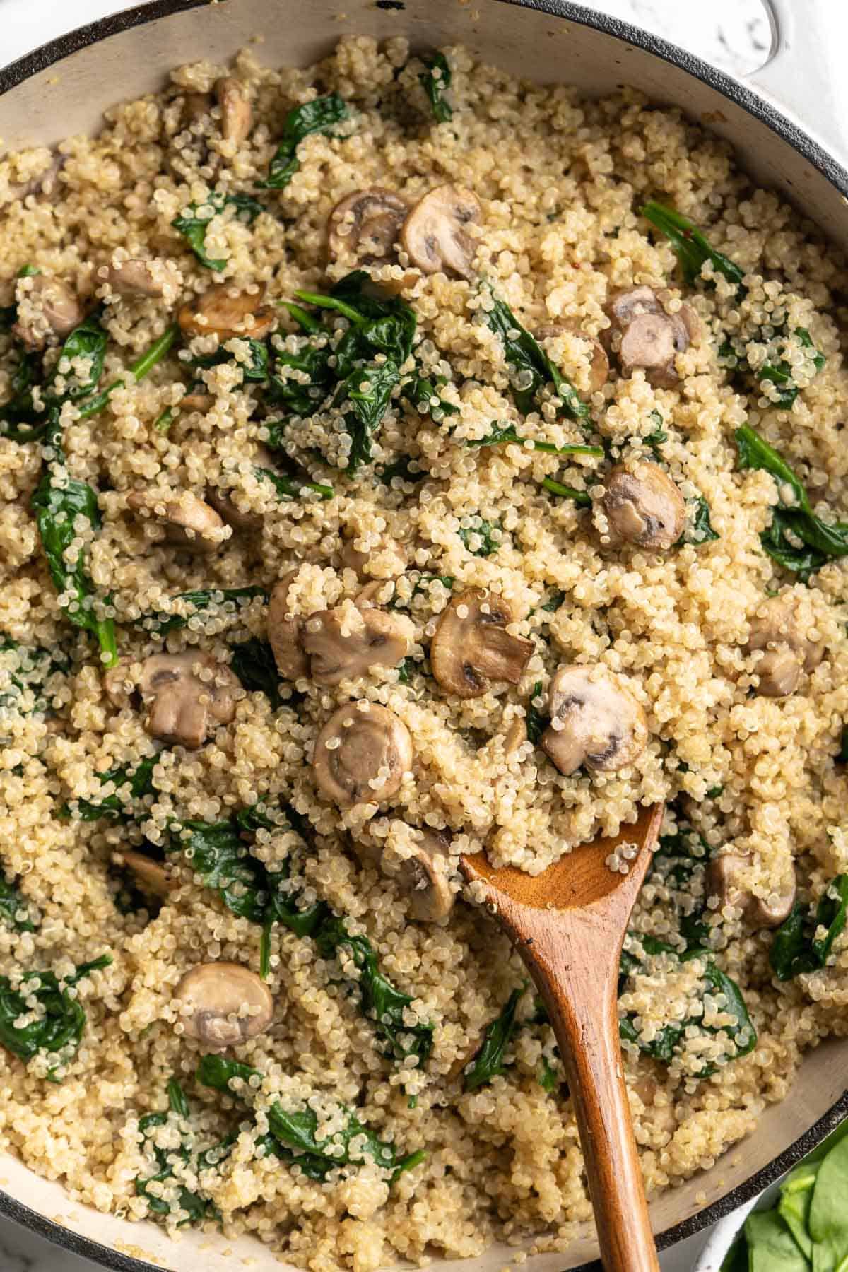 Overhead view of coconut creamy spinach and mushroom quinoa in skillet