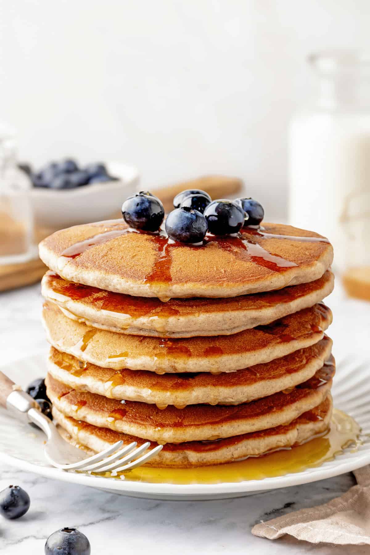 Stack of buckwheat pancakes on plate with fork