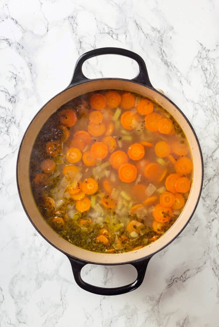 Overhead view of vegan chicken noodle soup before adding pasta