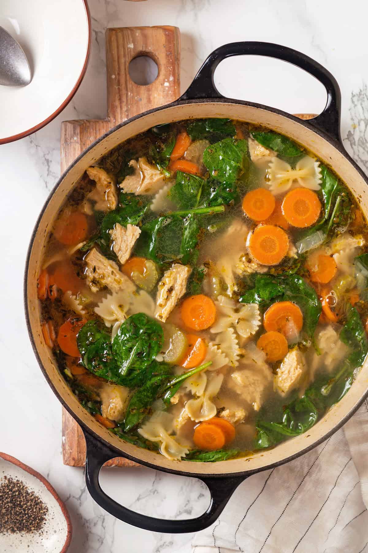 Overhead view of vegan chicken noodle soup in Dutch oven