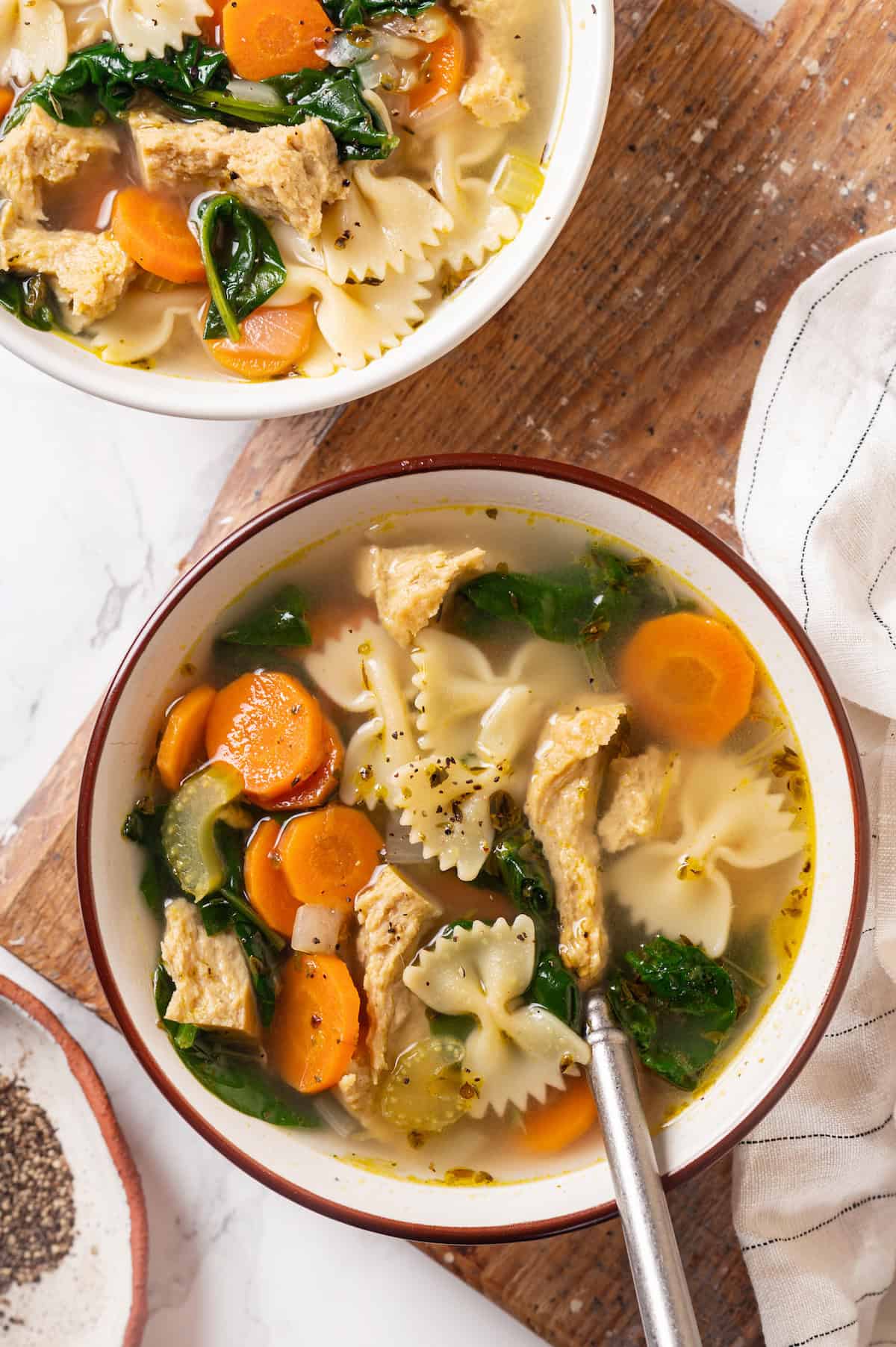 Overhead view of vegan chicken noodle soup in 2 bowls