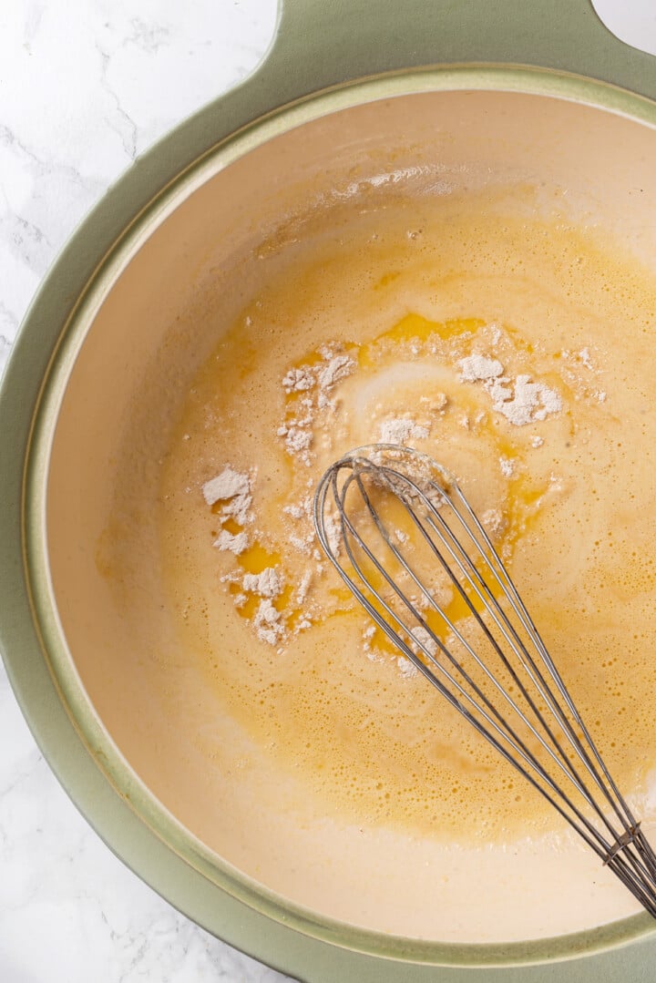 Overhead view of whisk mixing flour into butter for roux