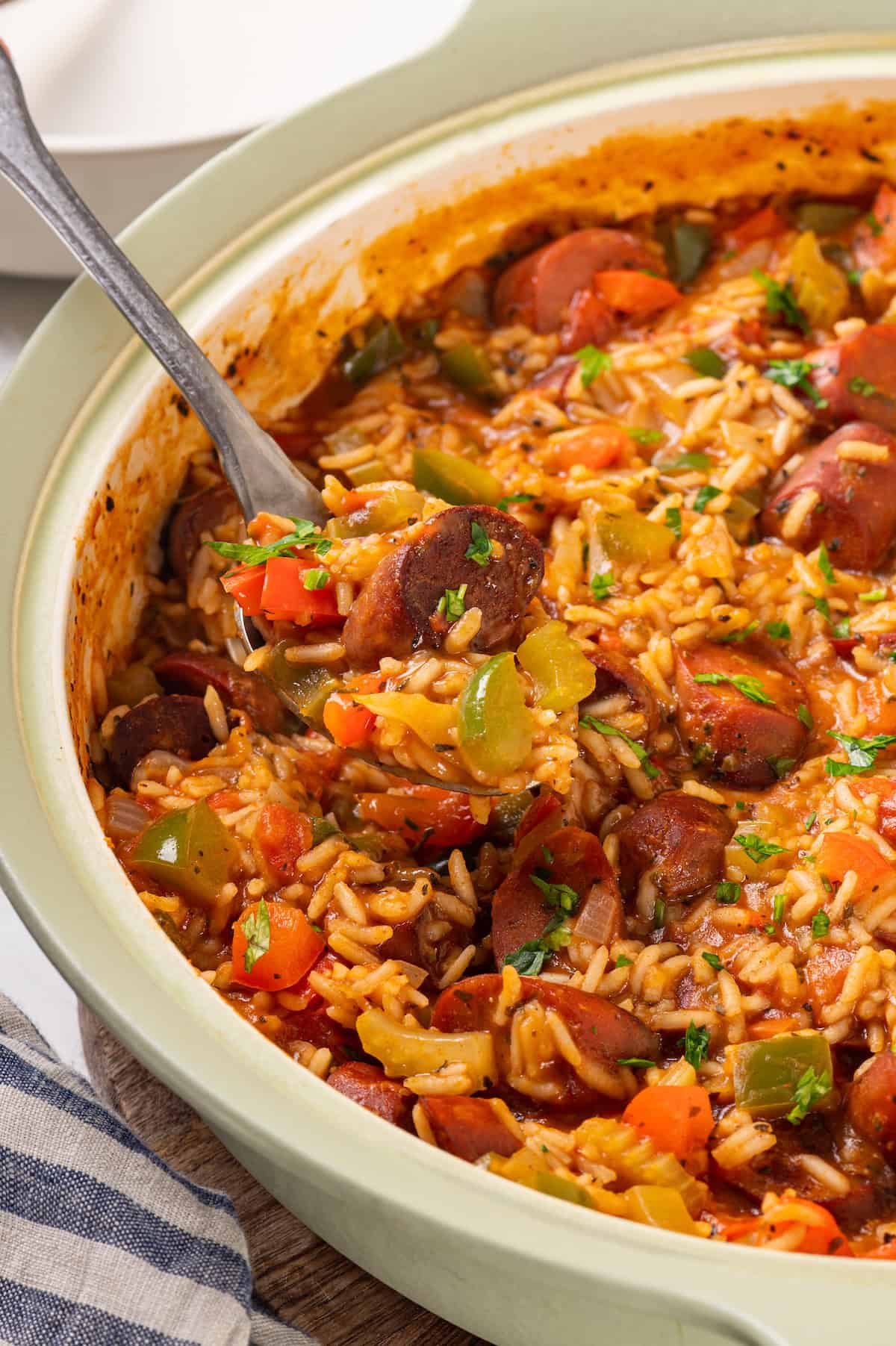 Skillet of vegan jambalaya with serving spoon