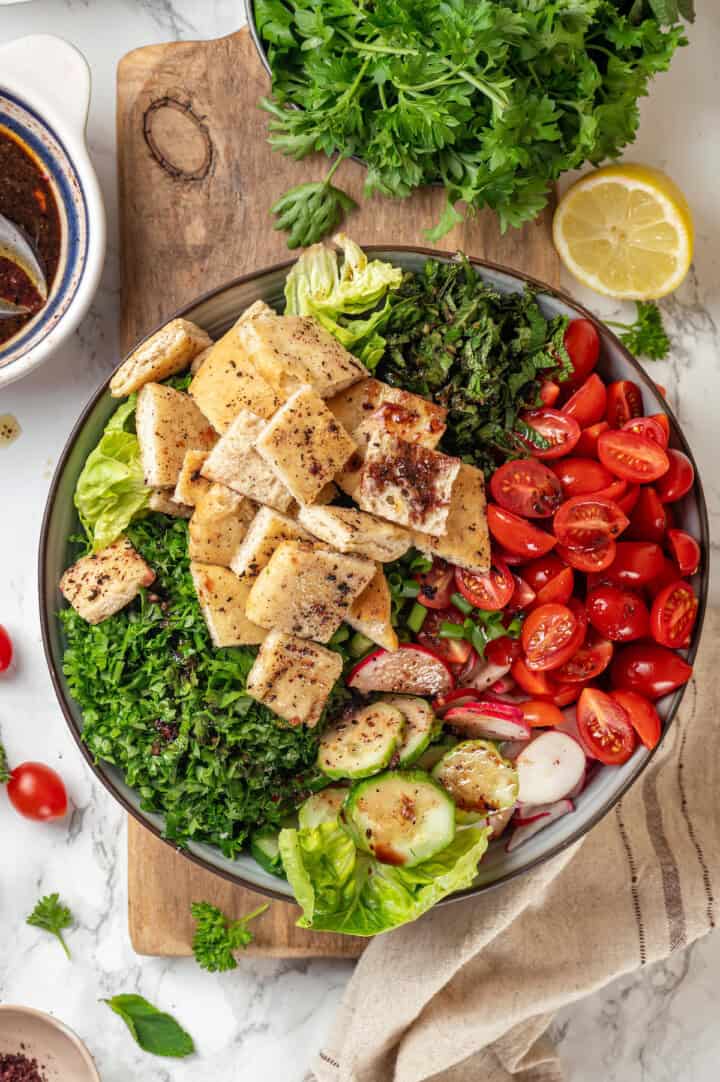 Overhead view of ingredients for fattoush salad in bowl