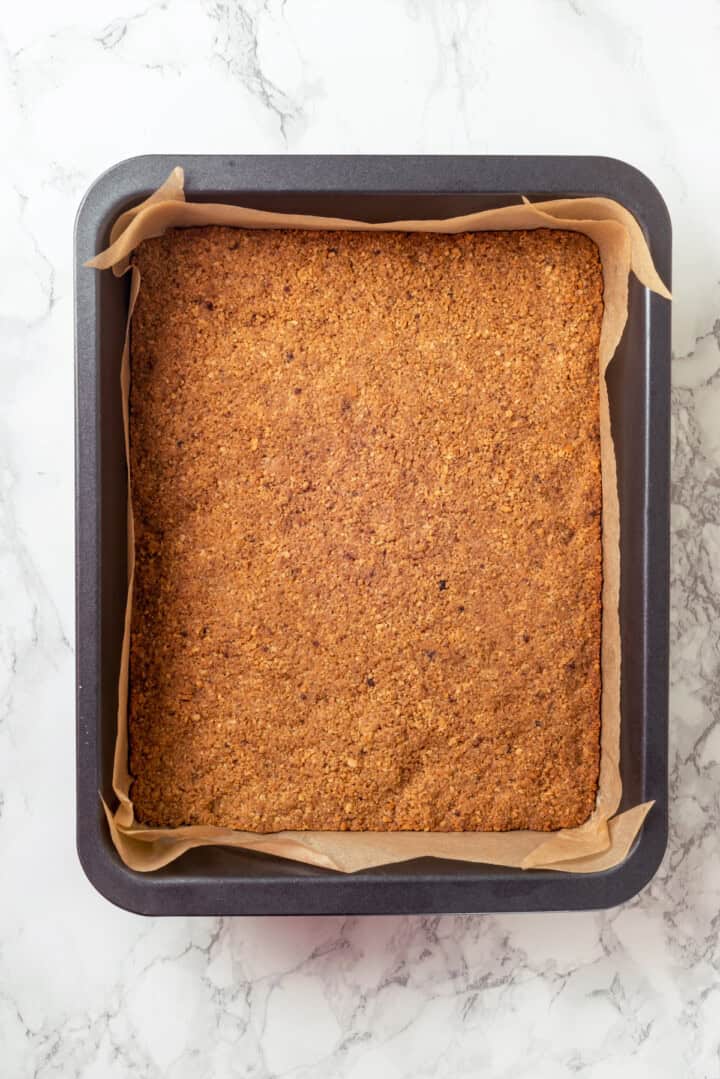 Overhead view of graham cracker crust for seven layer bars