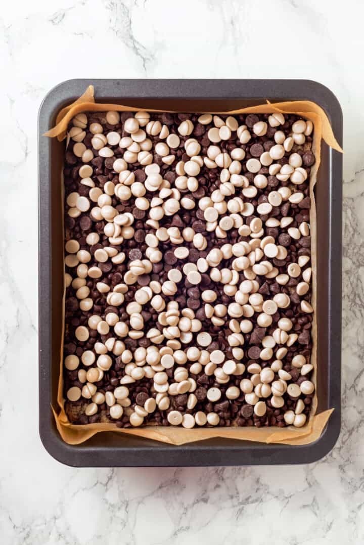 Overhead view of seven layer bars after adding chocolate chips