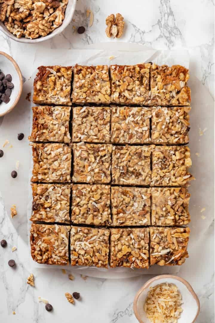 Overhead view of cut seven layer bars on parchment paper