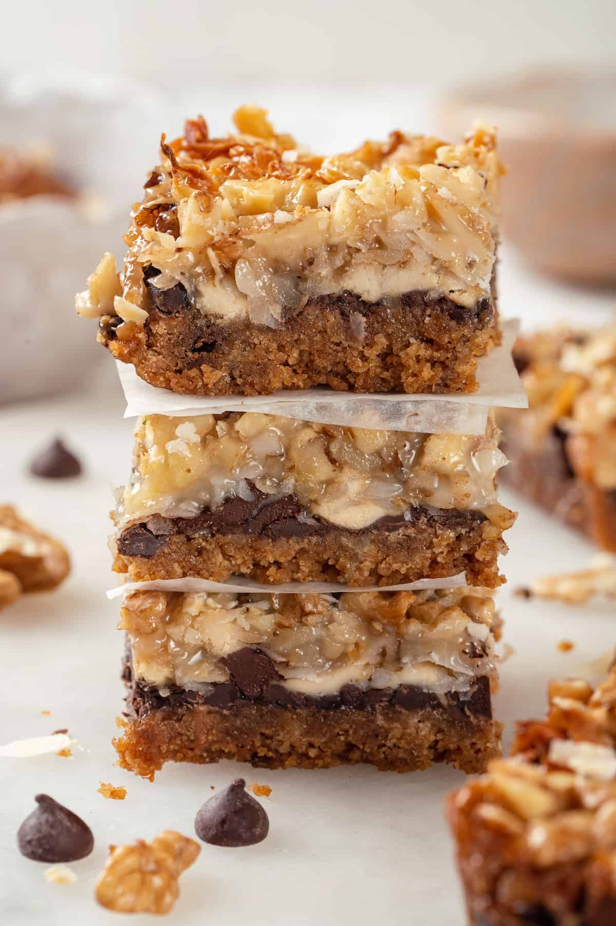 Three stacked seven layer bars with parchment between them