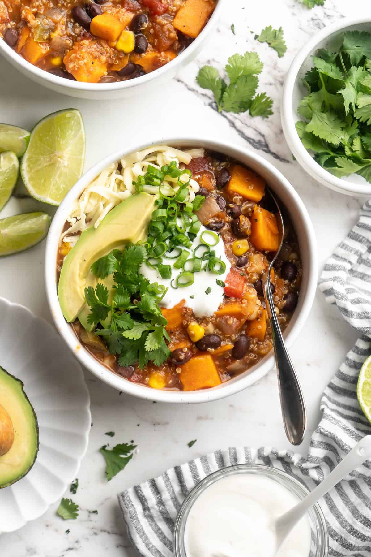 Overhead view of vegan sweet potato and black bean chili in bowl with spoon