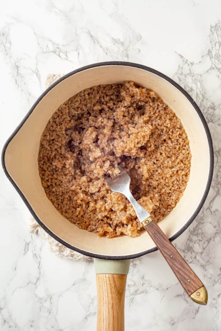 Overhead view of cooked bulgur in saucepan