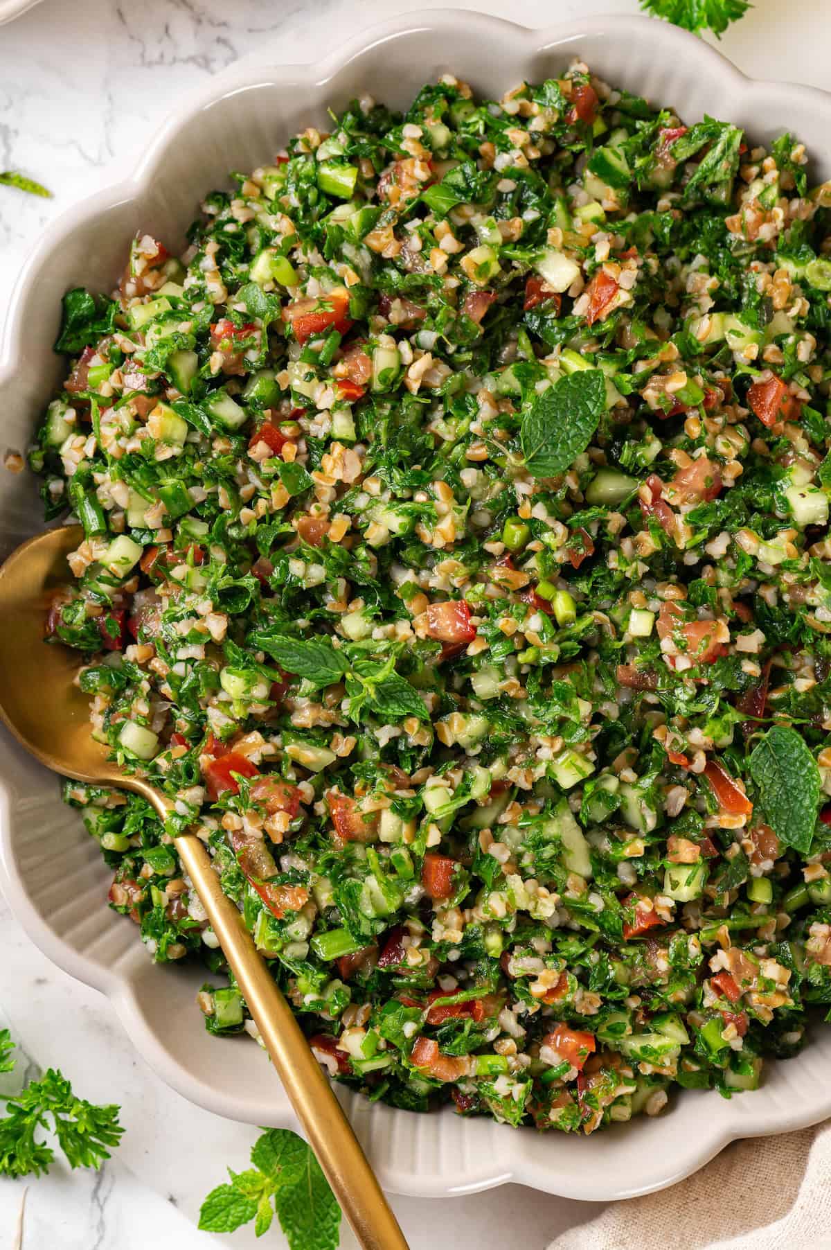 Overhead view of tabbouleh in serving bowl with spoon