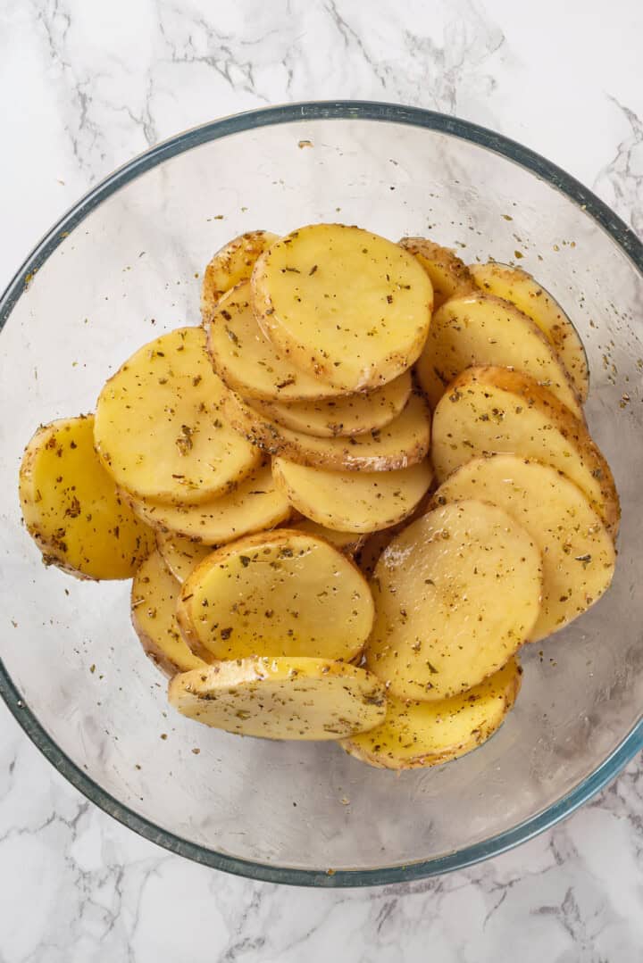 Overhead view of potato slices in bowl