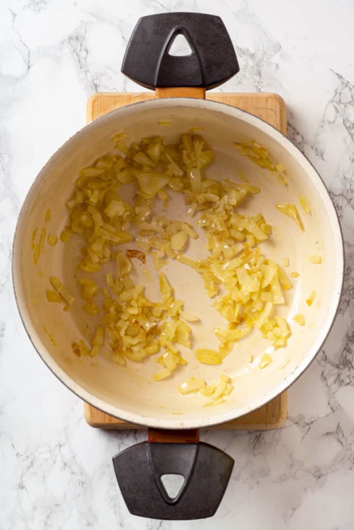 Overhead view of onions and garlic in pan