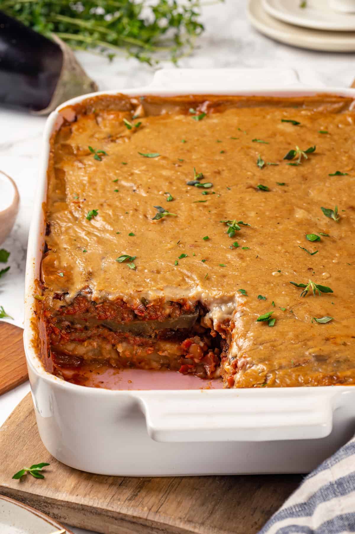 Baking dish of vegan moussaka with portion removed