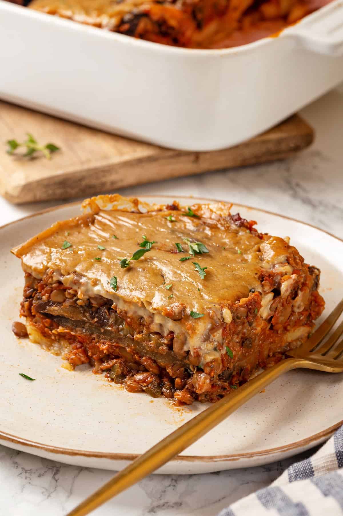 Portion of vegan moussaka on plate with fork