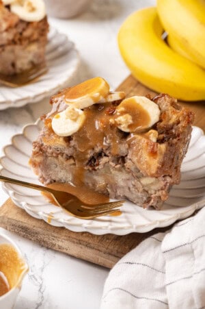 Caramel-topped banana bread pudding on plate with fork