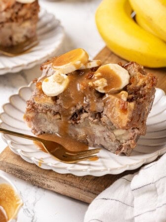 Caramel-topped banana bread pudding on plate with fork