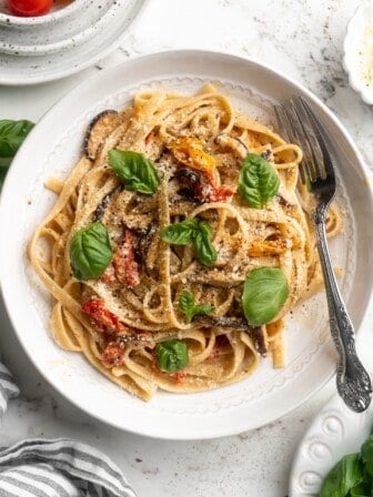 Overhead view of creamy garlic pasta on plate with fork