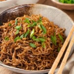 Spicy ramen in bowl with green onions for garnish