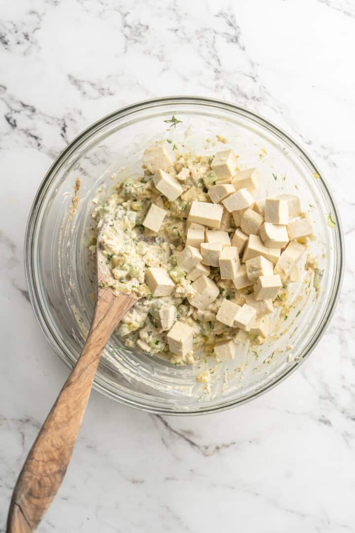 Stirring cubed tofu into tofu egg salad