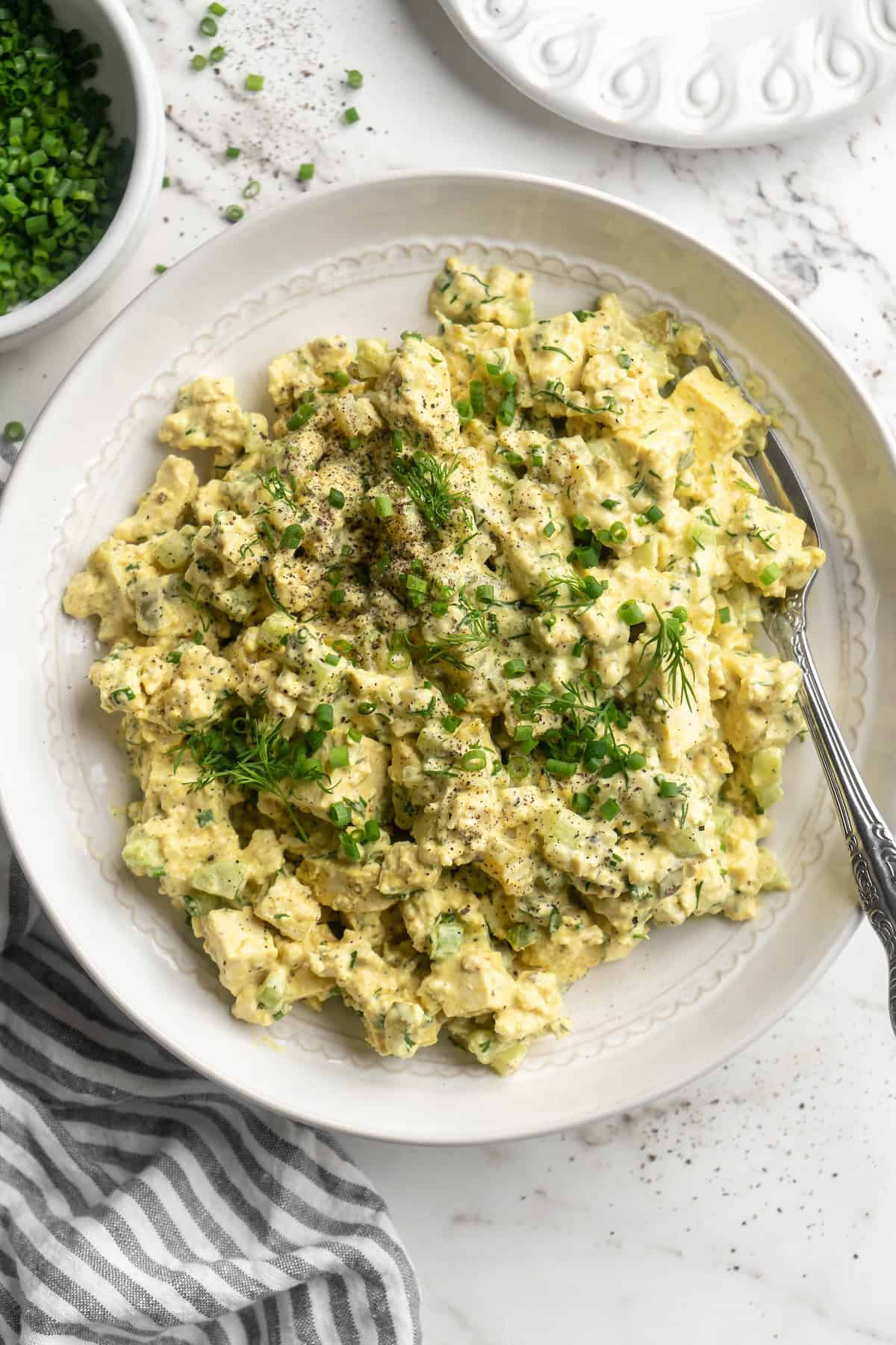 Overhead view of tofu egg salad in bowl with fork