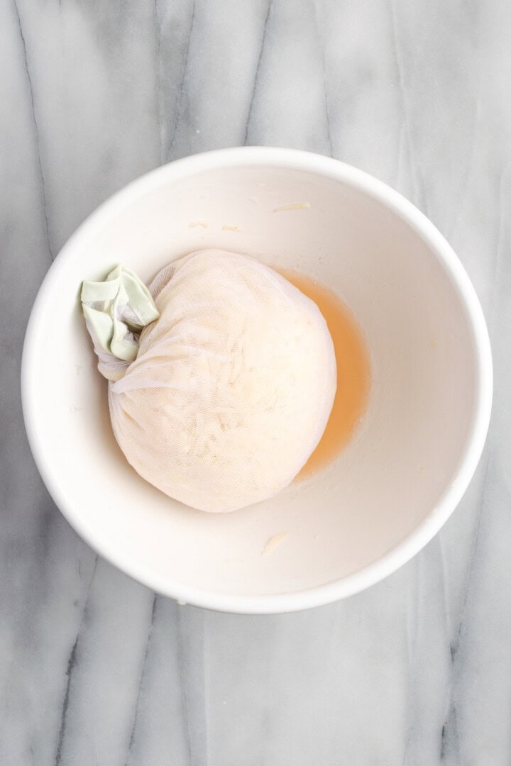 Potatoes wrapped in cheesecloth in bowl