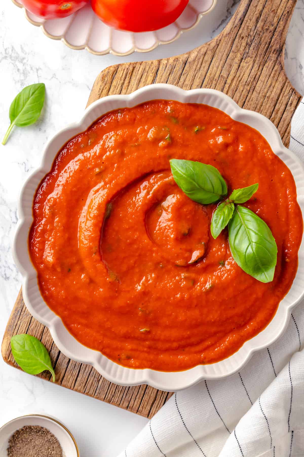 Overhead view of pomodoro sauce in bowl with basil