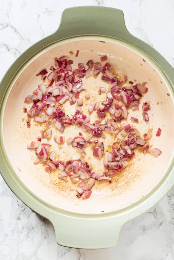 Overhead view of onion cooking in skillet