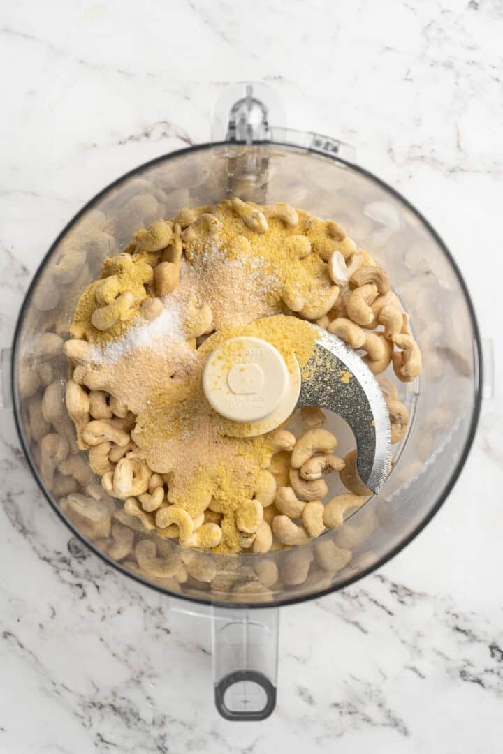 Overhead view of ingredients for vegan Parmesan cheese in food processor