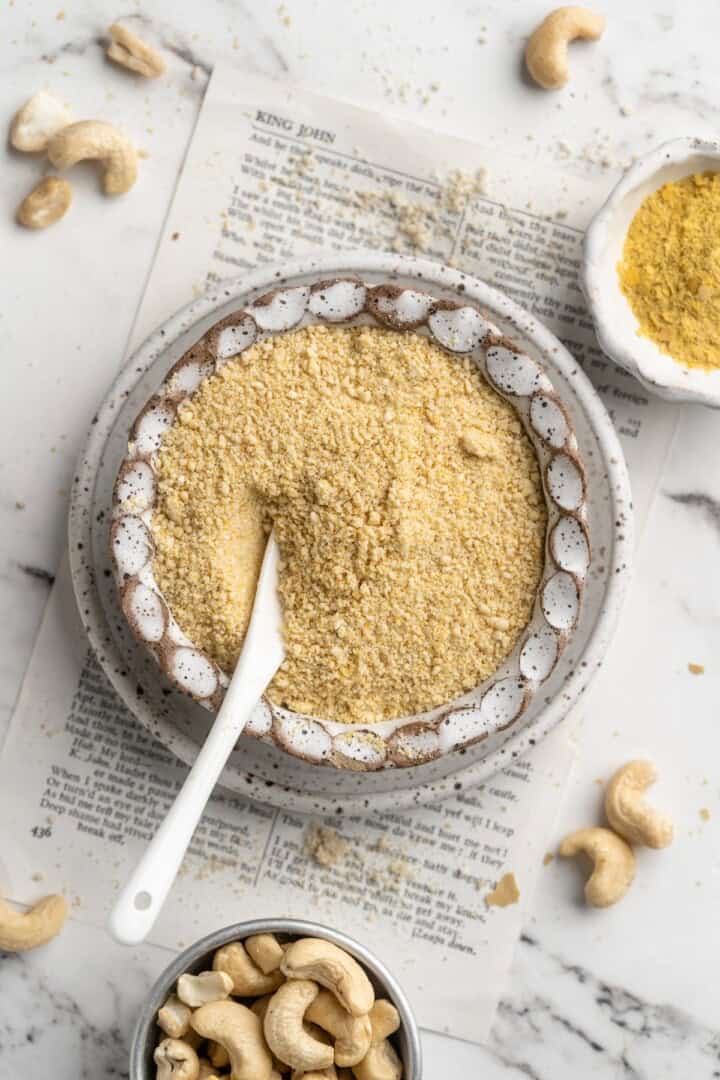 Cashew vegan Parmesan cheese in bowl with spoon