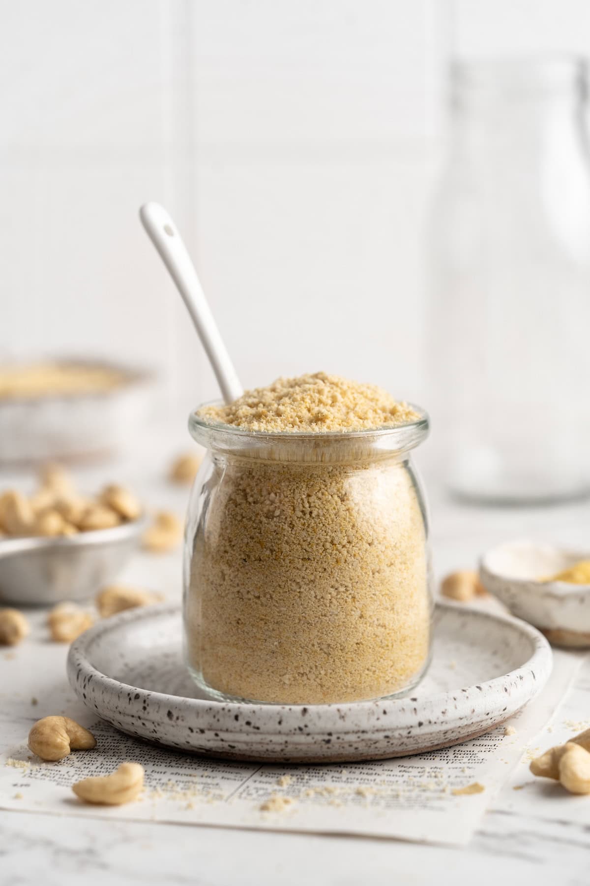 Homemade vegan Parmesan cheese in jar with spoon