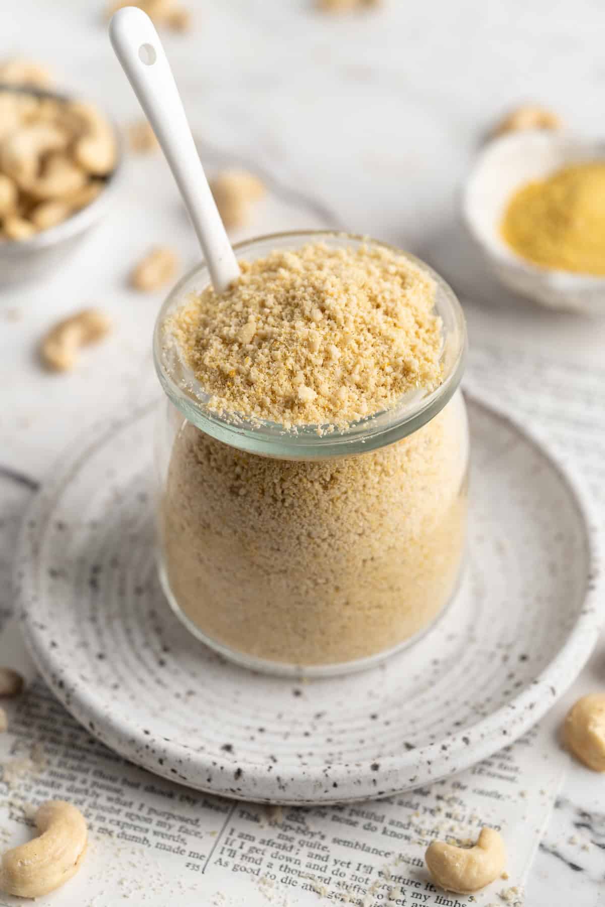 Jar of vegan Parmesan cheese with spoon