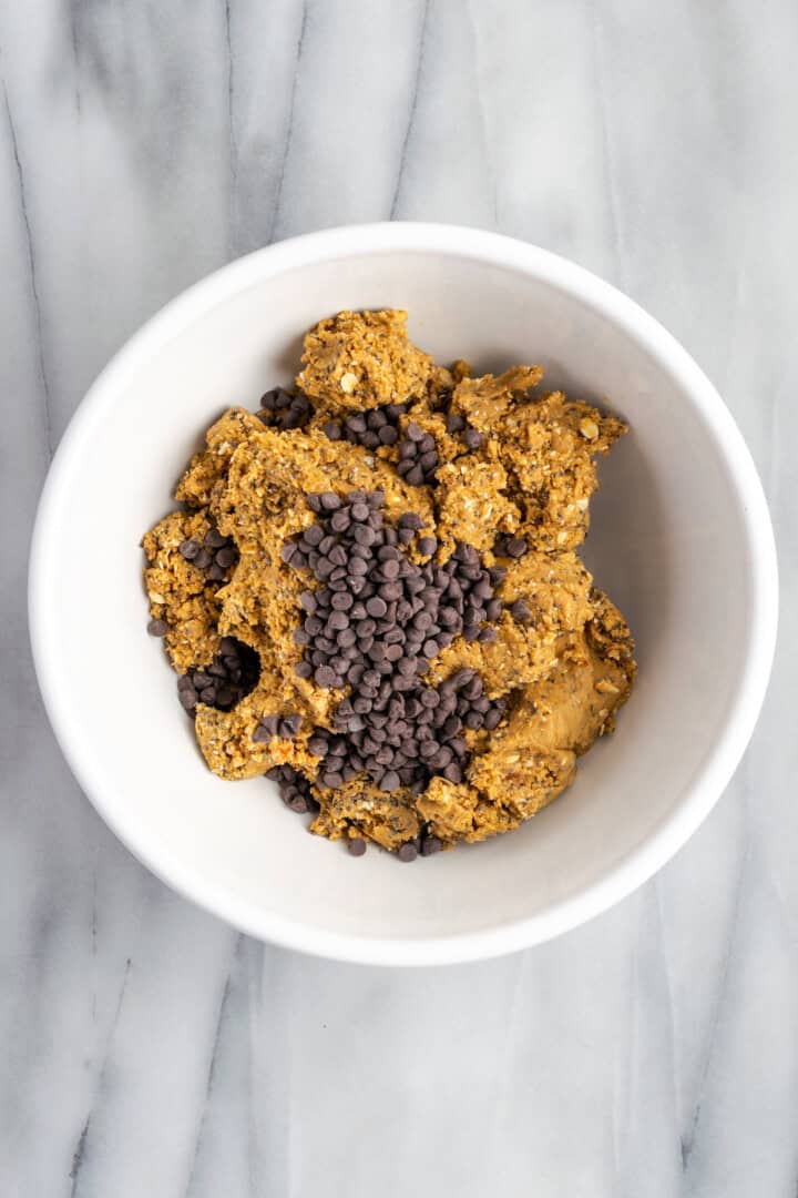 Chocolate chips added to bowl of mixture for protein bars