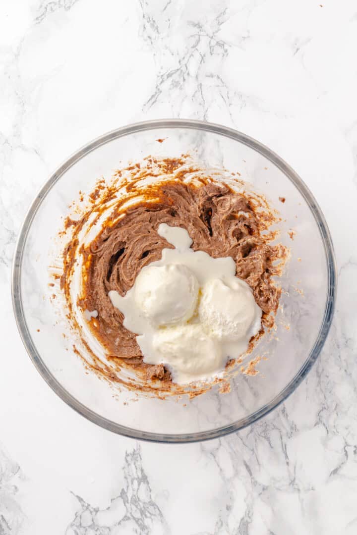 Overhead view of ice cream added to butter mixture in mixing bowl