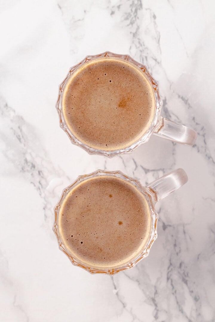 Overhead view of vegan hot buttered rum in mugs